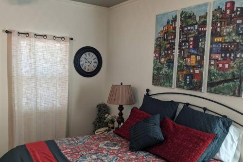 a bedroom with a bed and a clock on the wall at Sweet Mountain Cabin in Squaw Valley