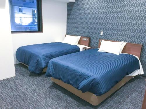 En eller flere senge i et værelse på HOTEL LiVEMAX Shinjuku Kabukicho-Meijidori
