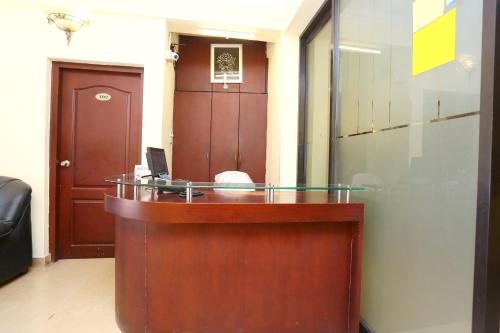 a reception desk in a room with a door at Hotel Day Springs in Kottayam