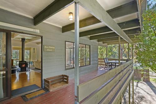 
a room with a wooden floor and a large window at Beechworth Holiday Park in Beechworth
