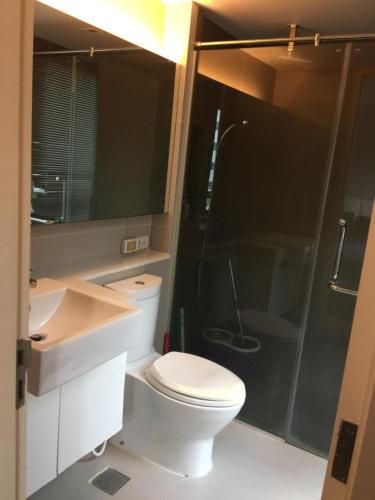 a bathroom with a toilet and a shower and a sink at Liv at 5 room41 in Bangkok