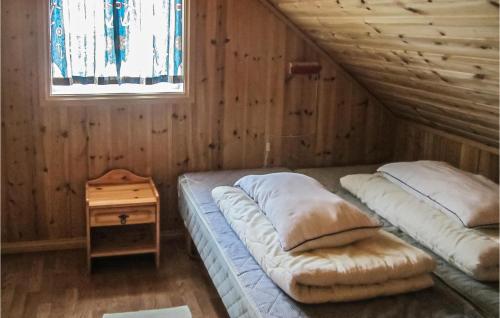a room with two beds in a wooden house at Cozy Home In Spangereid With Wifi in Korshamn