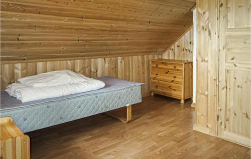 a bed in a room with a wooden ceiling at Cozy Home In Spangereid With Wifi in Korshamn
