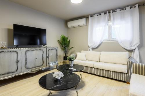 a living room with a couch and a table at Louloudis Apartment in Limenas