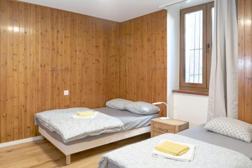 sypialnia z dwoma łóżkami i oknem w obiekcie Hôtel du Cheval-Blanc w mieście La Chaux-de-Fonds