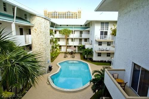 a swimming pool in the courtyard of a building at Suites at Coral Resorts in Miami