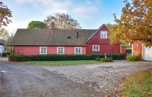 a red house with a driveway in front of it at Stunning Home In Ystad With Sauna in Ystad