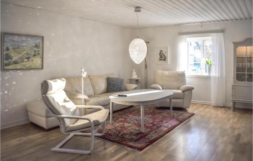 a living room with a couch and a table and chairs at Stunning Home In Ystad With Sauna in Ystad