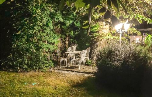 a table and chairs in a garden at night at Stunning Home In Ystad With Sauna in Ystad