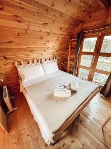 ein Bett in einer Blockhütte mit zwei Handtüchern darauf in der Unterkunft Tenuta Morganti in Torano Nuovo