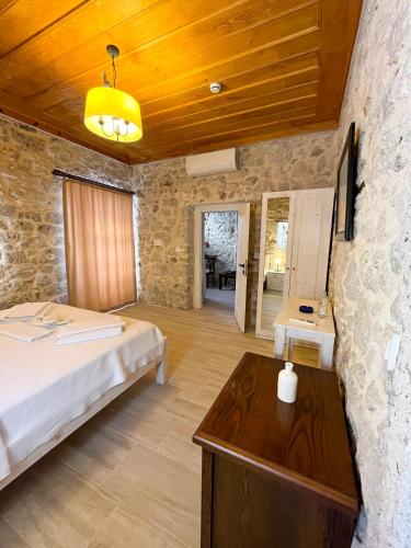 a bedroom with a bed and a wooden ceiling at Merlara Otel Alaçatı in Alaçatı