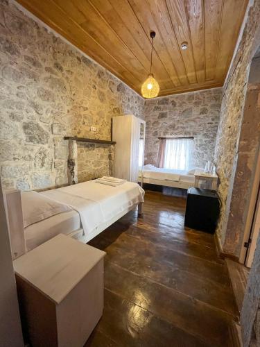 a bedroom with a bed and a table in a room at Merlara Otel Alaçatı in Alaçatı