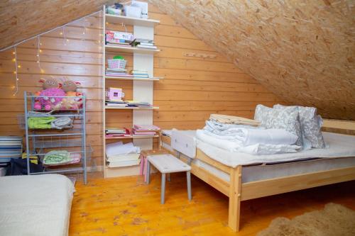 a bedroom with a bed and shelves in a attic at Kuuseoksa Holiday Home in Viru-Nigula