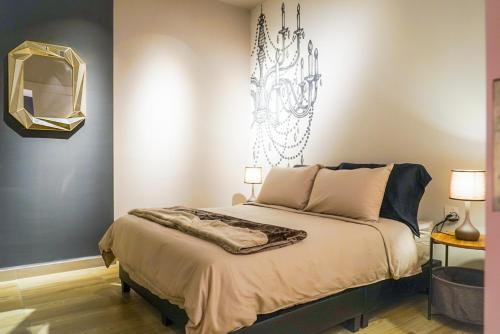 a bedroom with a bed with a mirror on the wall at Octagon Ipoh by Plush in Ipoh