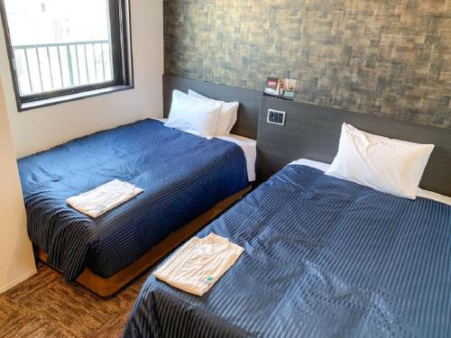 Säng eller sängar i ett rum på HOTEL LiVEMAX Shinjuku Kabukicho