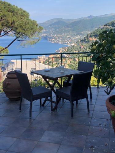 a table and chairs on a balcony with a view at Casa Portofino in Camogli