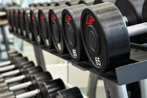 a row of black dumbbells in a gym at Auberge Vancouver Hotel in Vancouver