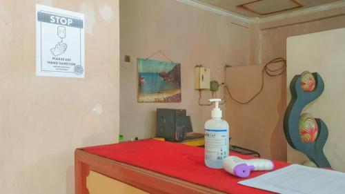 a bottle of hand sanitizer sitting on top of a table at Hotel Jaya Kusuma near Candi Prambanan Mitra RedDoorz in Prambanan