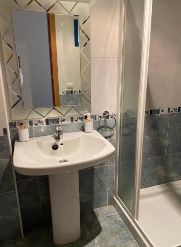 a bathroom with a sink and a shower at Isla de Tambo in Combarro