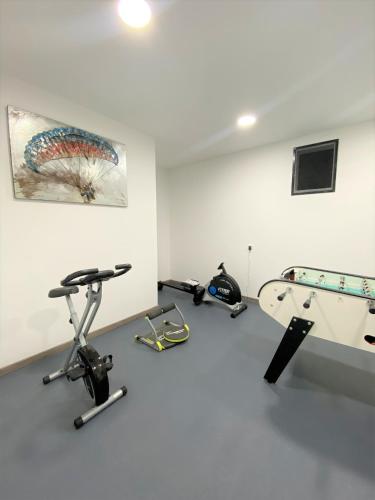 a room with a gym with a treadmill and a table at Tres belle villa neuve vue mer avec piscine chauffee in Sainte-Lucie de Porto-Vecchio