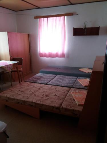 a bedroom with two beds and a window at Zotavovna Kvilda in Kvilda