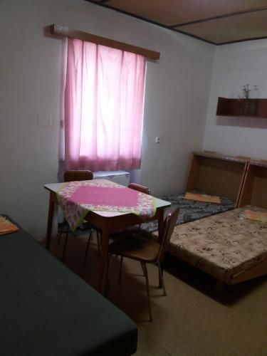 a room with a table and chairs and a window at Zotavovna Kvilda in Kvilda