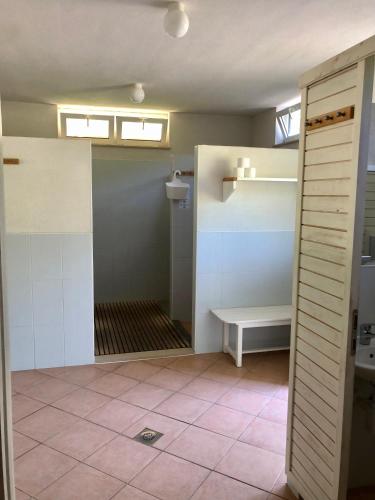 a bathroom with a sink and a bench in a room at Una Kamp in Bosanska Krupa
