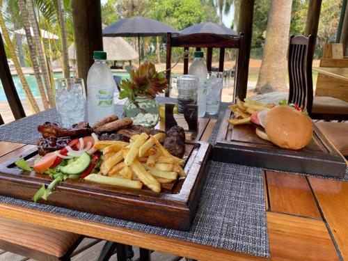 a tray of food with a hamburger and french fries at Nabana Lodge in Hazyview