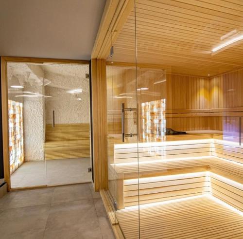 um quarto com uma sauna com uma parede de vidro em Titova Vila Zlatibor Mountain View Apartment em Zlatibor