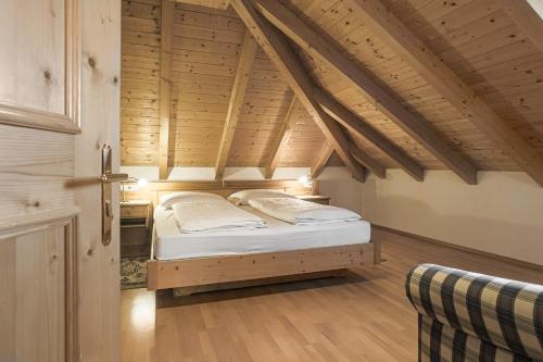 a bedroom with a bed in an attic at Appartements Eppanerhof in Appiano sulla Strada del Vino