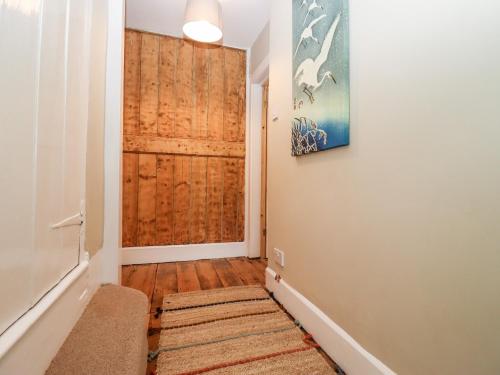 a hallway with a wooden door in a house at Ley Mill Farm in Westbury on Severn
