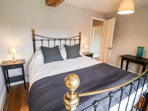 a bedroom with a large bed with blue pillows at Ley Mill Farm in Westbury on Severn