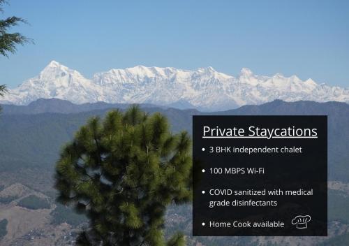 a sign with a pine tree and mountains in the background at Hostie Onella - Private 3BHK Mountain Chalet with breathtaking Himalayan views in Rānīkhet
