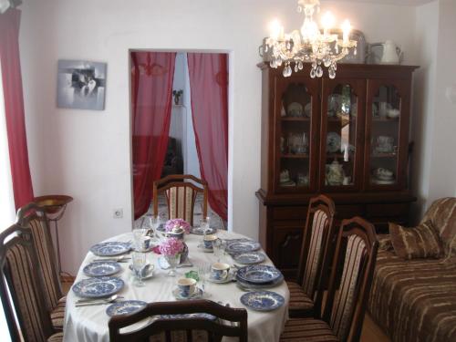 a dining room table with blue and white dishes on it at Wisteria in Tivat
