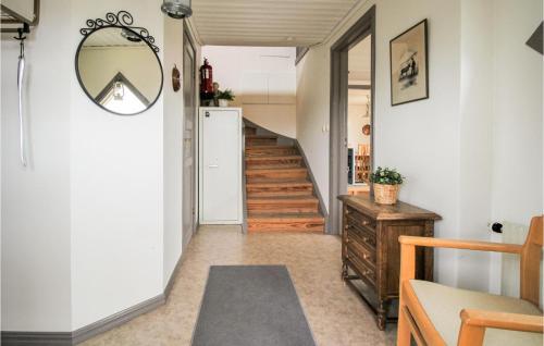 a hallway with stairs and a mirror on the wall at Stunning Home In Lidhult With Wifi in Lidhult