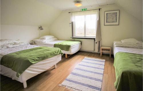 a room with three beds and a window at Stunning Home In Lidhult With Wifi in Lidhult