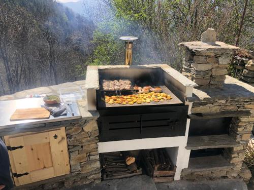 an outdoor grill with food on top of it at Casa Miki in Roure Turin