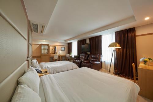 
a hotel room with a large bed and a large window at Gyeongju GG Tourist Hotel in Gyeongju
