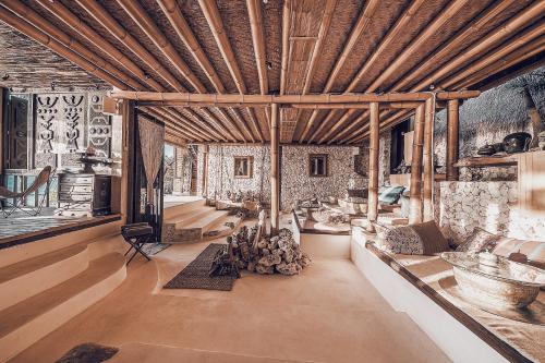 a living room with a large wooden ceiling at The Baha House in Uluwatu