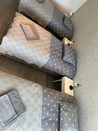an overhead view of a bed with pillows and a book at Kemi CITY III near snowcastle, premium 2 rooms , kitchen , glazed balcony, FREE private parking in Kemi