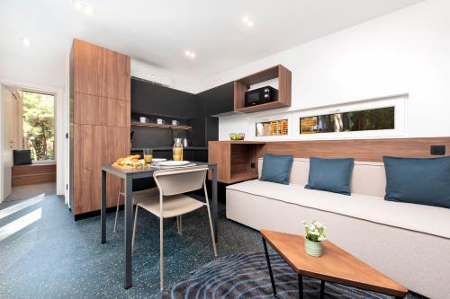 a bedroom with a bed and a table in a room at Porton Nature Hideouts in Rovinj