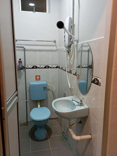 a bathroom with a blue toilet and a sink at D LAYARAN KUANTAN LPT Exit 833 in Kuantan