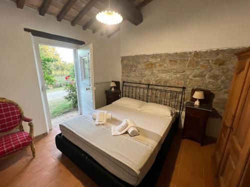 a bedroom with a bed with two towels on it at Agriturismo Baratti in Baratti