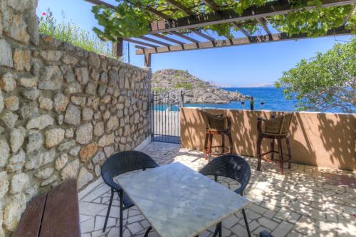 a table and chairs on a patio overlooking the ocean at Casa al mare in Sveti Juraj
