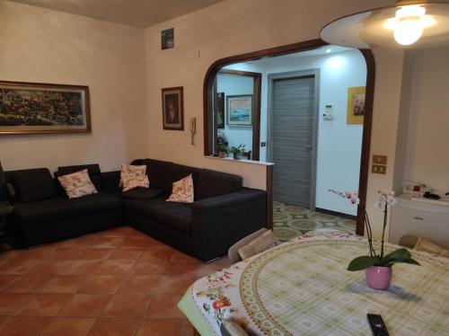 a living room with a couch and a table at Camera a Palermo in Mondello