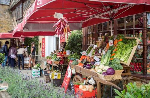 a farmers market with fruits and vegetables on display at Little Gables in Broadway