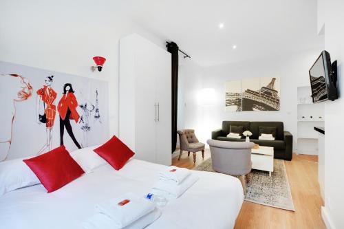 a bedroom with a white bed with red pillows at CMG - Cosy Studio 4P Tiquetonne Chatelet in Paris