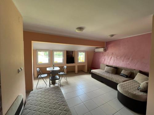 a living room with a couch and a table at Apartmani Plaža in Bor