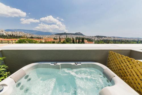 a jacuzzi tub on a balcony with a view at Athens Panorama Project in Athens