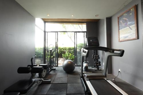 a gym with two exercise machines and a window at Cochin Zen Hotel in Ho Chi Minh City